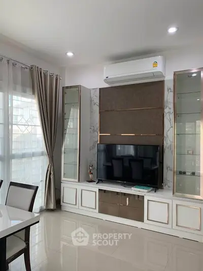 Modern living room with sleek TV unit and air conditioning