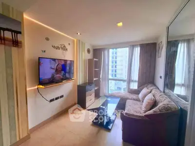 Spacious living room with modern decor and large windows offering city views.