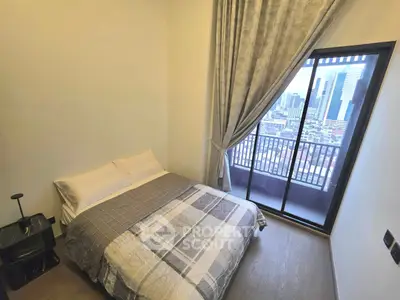 Modern bedroom with city view and large window balcony access