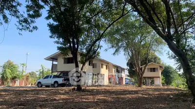 Spacious property with two houses surrounded by trees and open land, ideal for development.