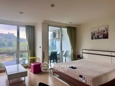 Spacious bedroom with balcony and scenic view in modern apartment