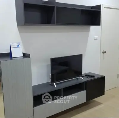 Modern living room with sleek TV stand and wall-mounted shelves, perfect for stylish urban living.