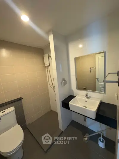 Modern bathroom with sleek fixtures and spacious shower area