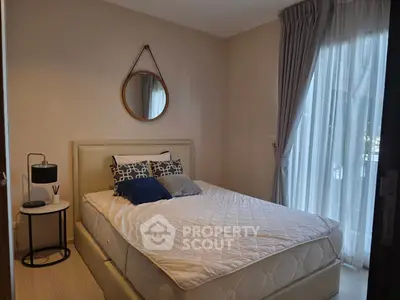 Cozy bedroom with stylish decor and natural light from large window