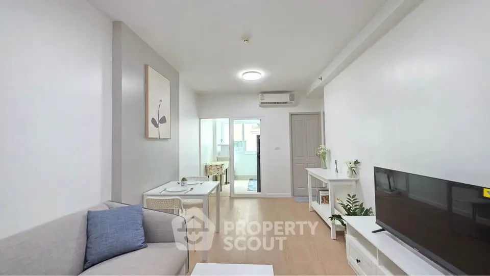 Modern living room with sleek furniture and natural light, featuring a cozy dining area and stylish decor.