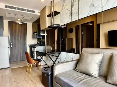 Modern living room with stylish decor and open kitchen layout in a contemporary apartment.