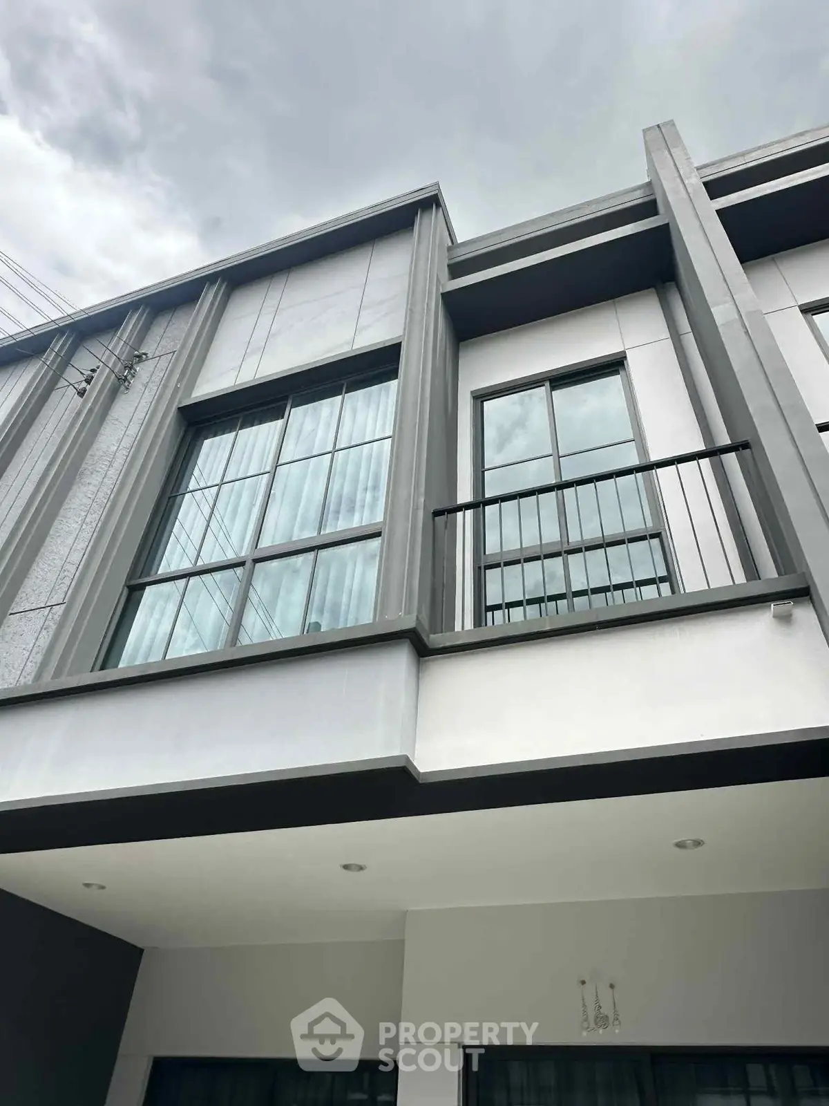 Modern building exterior with large windows and sleek architectural design.