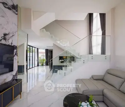 Luxurious modern living room with elegant staircase and marble accents
