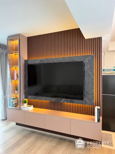 Modern living room with stylish TV wall unit and ambient lighting