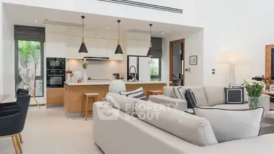 Modern open-plan living room with stylish kitchen and cozy seating area.