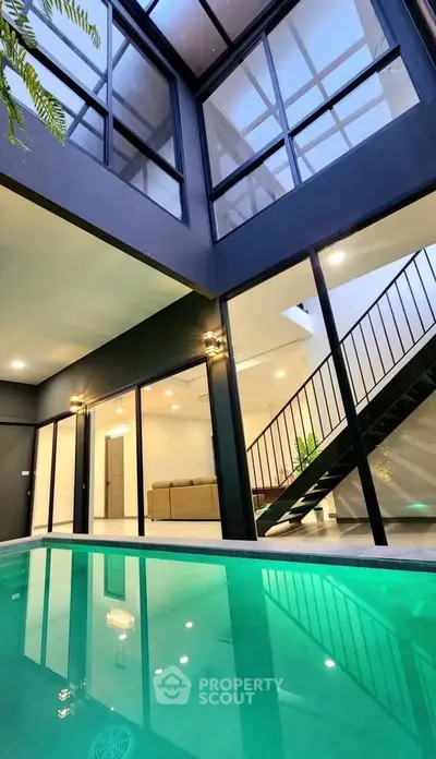 Modern luxury home with indoor pool and sleek staircase, perfect for contemporary living.