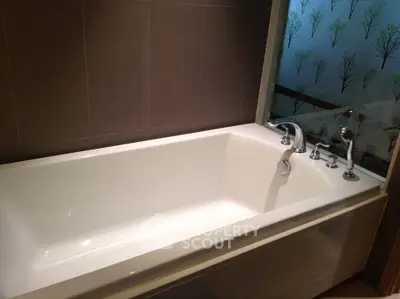 Luxurious bathroom with modern bathtub and elegant fixtures, perfect for relaxation.
