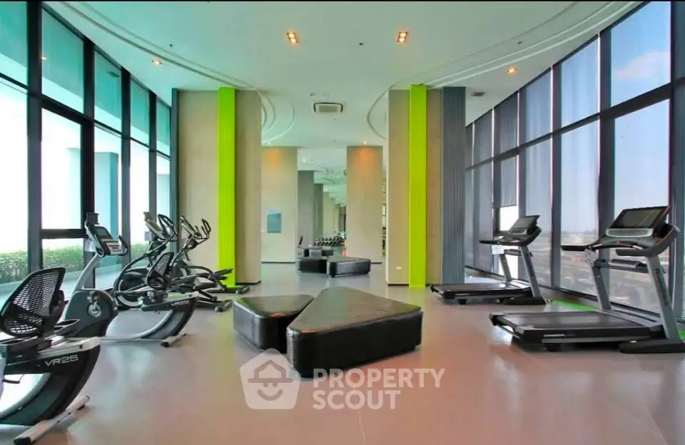 Luxurious high-rise gym with panoramic city views and modern fitness equipment.