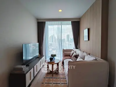 Modern living room with city view, cozy sofa, and large TV setup.