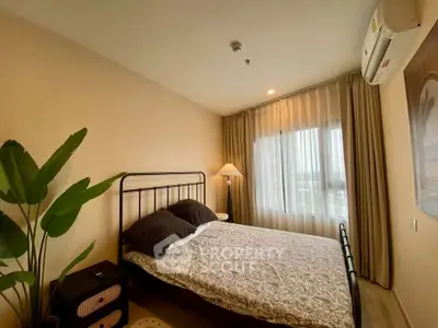 Cozy bedroom with elegant decor and large window in modern apartment