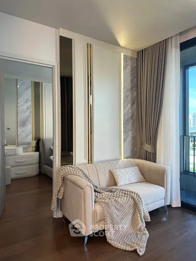 Luxurious bedroom with elegant decor and cozy seating area, featuring floor-to-ceiling windows.