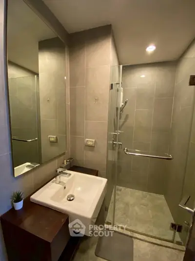 Modern bathroom with glass shower and sleek sink design