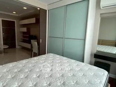 Modern bedroom with sliding closet doors and air conditioning in a stylish apartment.