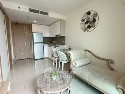 Chic modern living room with elegant sofa and compact kitchen in open layout apartment.