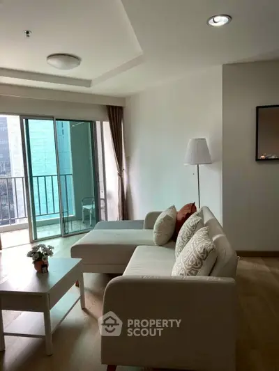 Modern living room with cozy sofa and balcony view in urban apartment