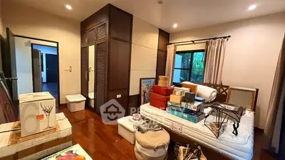 Spacious bedroom with wooden flooring and ample storage space, ideal for modern living.