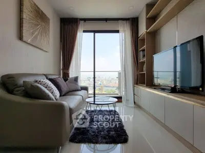 Modern living room with city view, stylish decor, and cozy seating area.