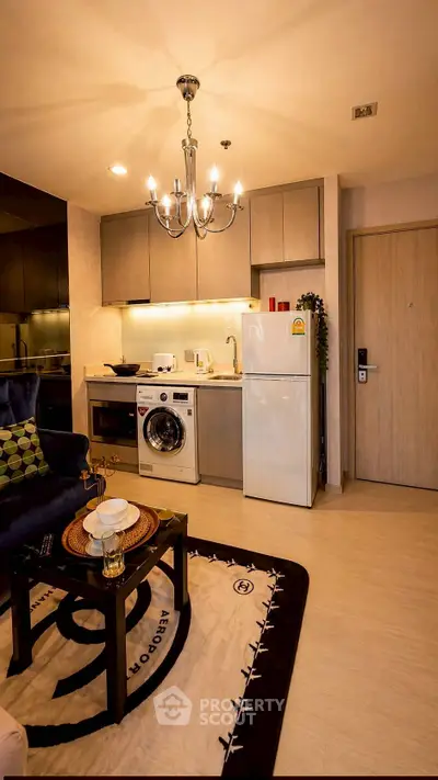 Modern kitchen with washing machine and fridge in cozy apartment