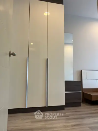 Modern bedroom with sleek wardrobe and minimalist design