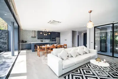 Luxurious open-plan living room with modern kitchen and stylish decor