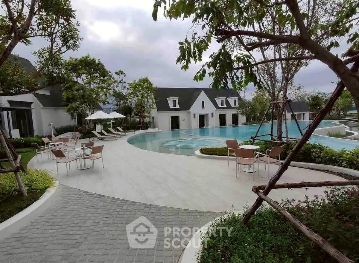 Luxurious residential pool area with modern design and lush greenery.