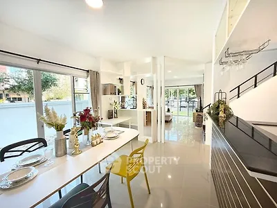 Modern open-plan kitchen and dining area with sleek design and abundant natural light.