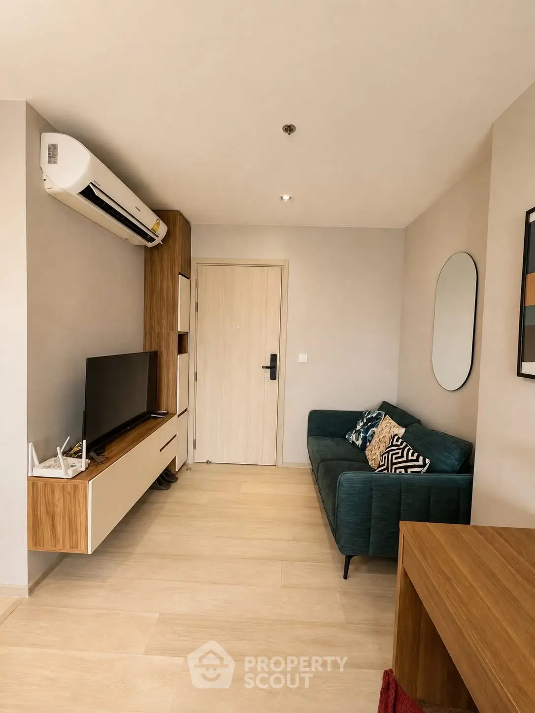 Modern living room with stylish decor and wall-mounted TV in a cozy apartment.