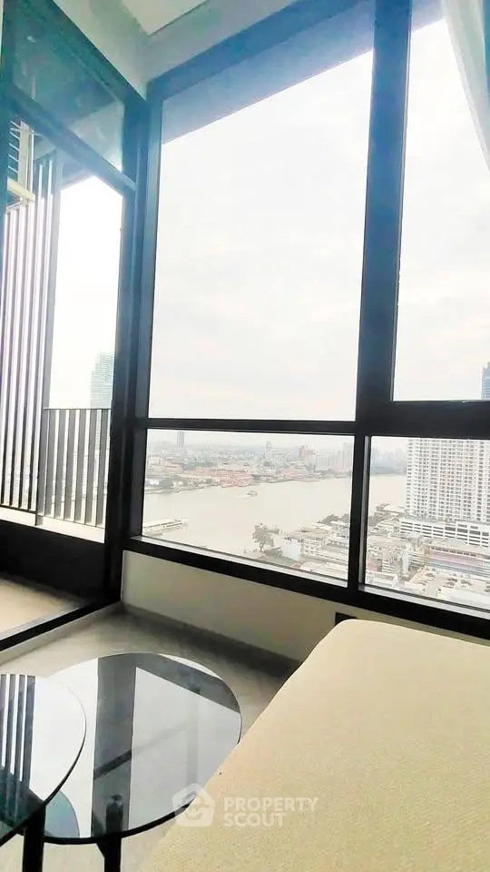 Stunning high-rise apartment with panoramic river view and floor-to-ceiling windows.