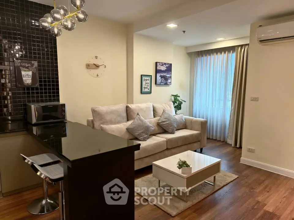 Modern living room with stylish decor and open kitchen layout.