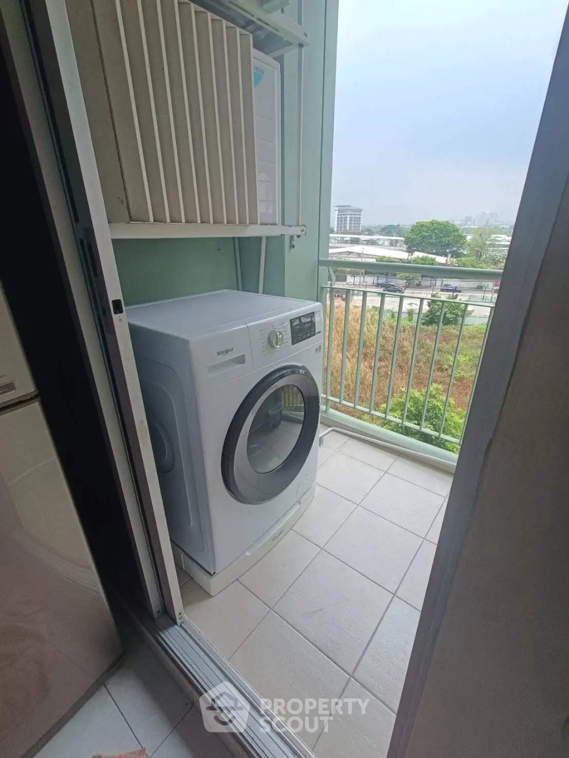 Compact balcony with washing machine overlooking scenic view