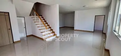 Spacious modern living room with sleek staircase and glossy floors