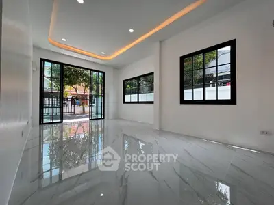 Modern living room with glossy marble floors and large windows