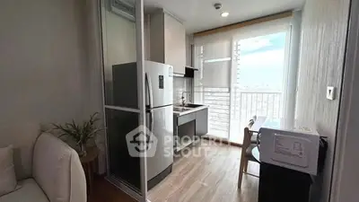 Modern compact kitchen with balcony view in high-rise apartment