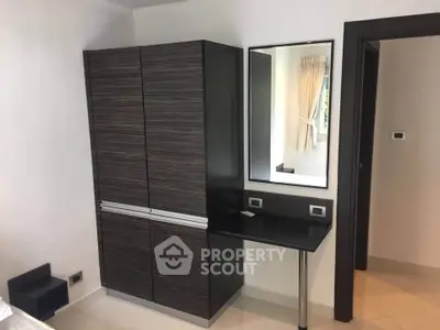 Modern bedroom with sleek wardrobe and stylish vanity mirror