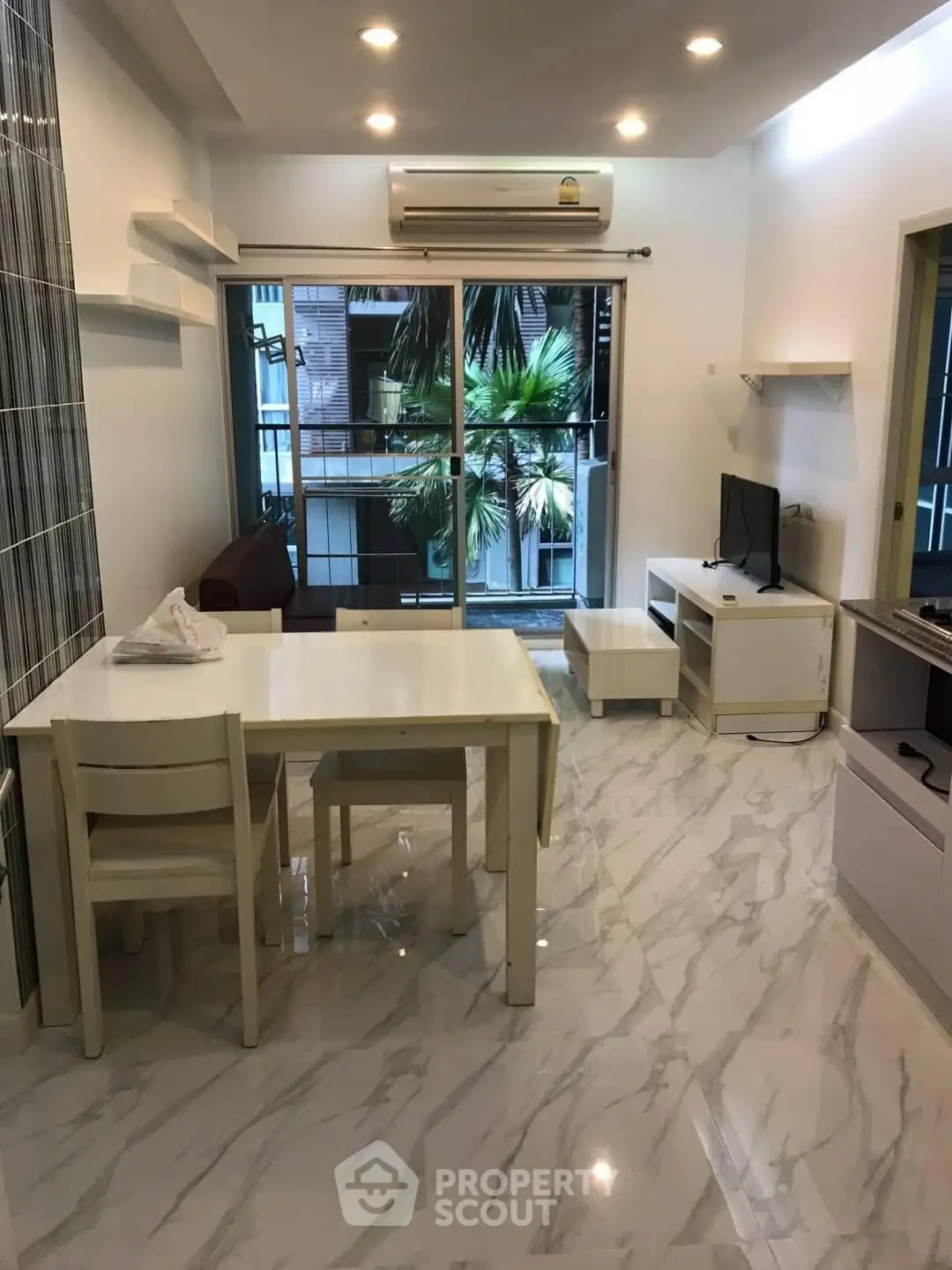 Modern living room with marble flooring, dining area, and large window view.
