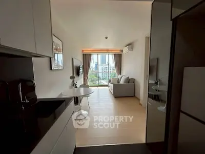 Modern open-layout apartment with city view, stylish kitchen, and cozy living area.
