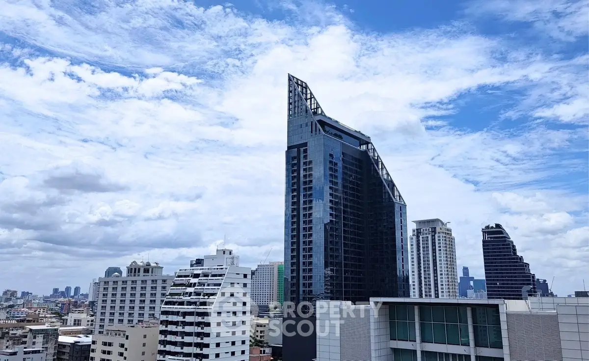 Stunning cityscape view featuring a modern high-rise building against a vibrant blue sky.