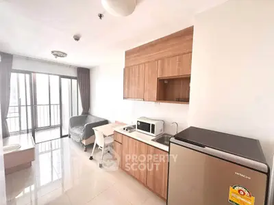 Modern studio apartment with sleek kitchen and balcony view