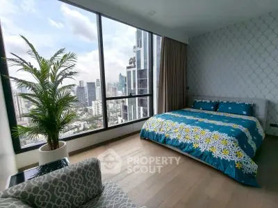 Luxurious bedroom with stunning city view and modern decor.
