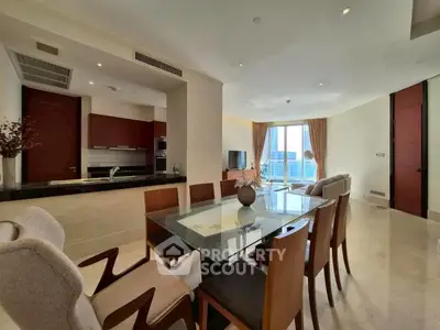 Elegant open-plan dining and living area with modern kitchen and city view.
