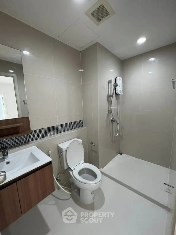 Modern bathroom with sleek fixtures and spacious shower area
