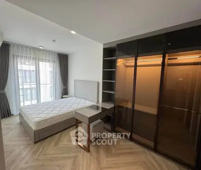 Modern bedroom with glass wardrobe and natural light
