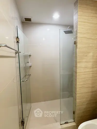 Modern bathroom with glass shower enclosure and sleek tile design