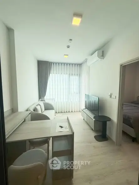 Modern living room with natural light, stylish furniture, and a cozy atmosphere in a contemporary apartment.