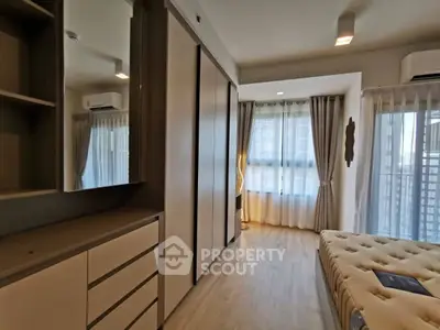 Modern bedroom with stylish decor and ample natural light